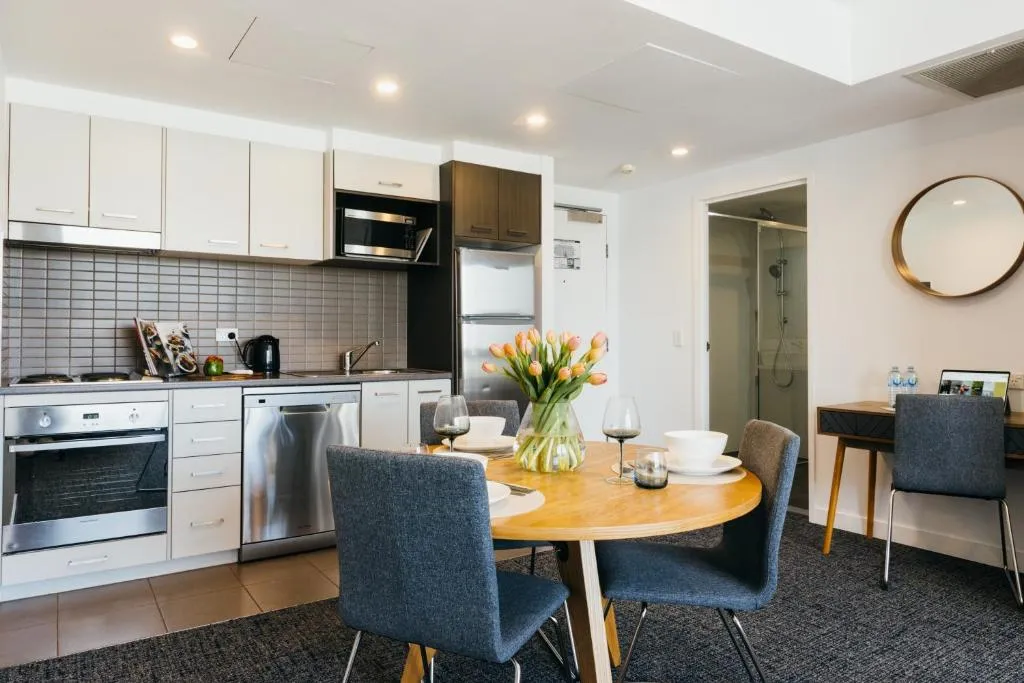 Kitchen and dining area in an apartment at Quest Mascot