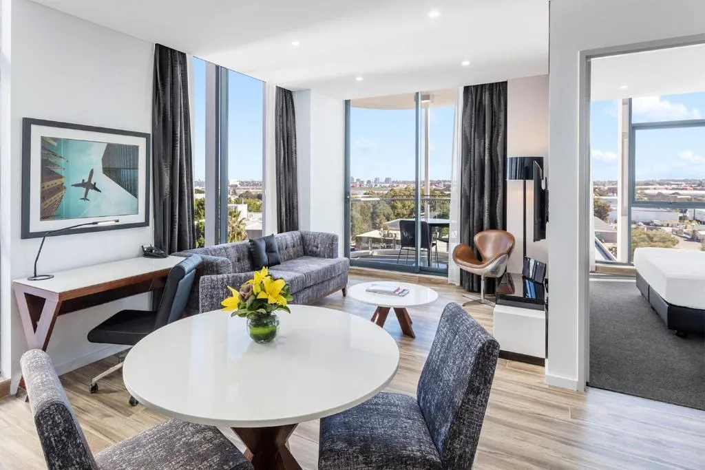 A suite living area with views at Meriton Suites Mascot Central